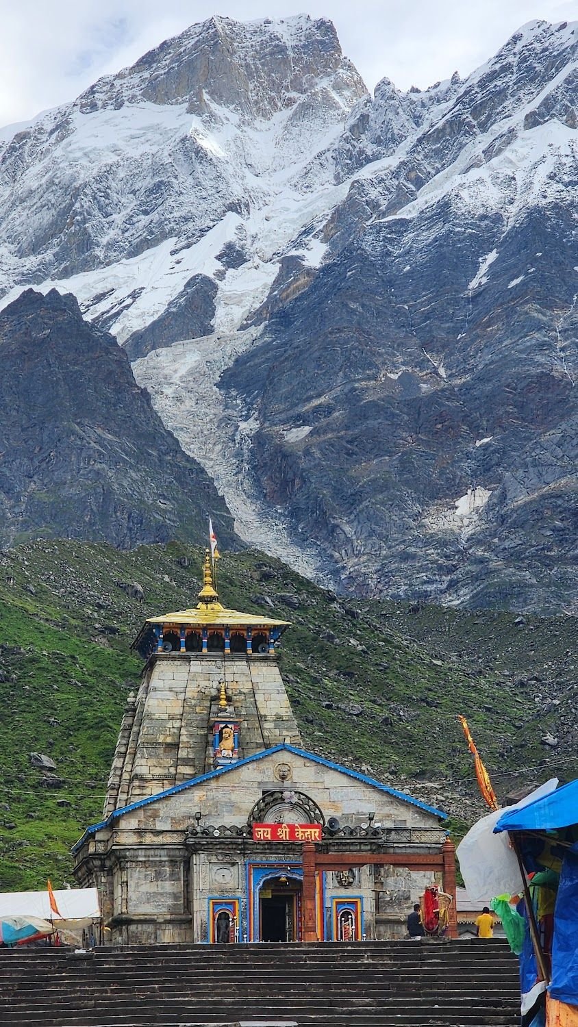 Kedarnath temple beneath a towering snow face