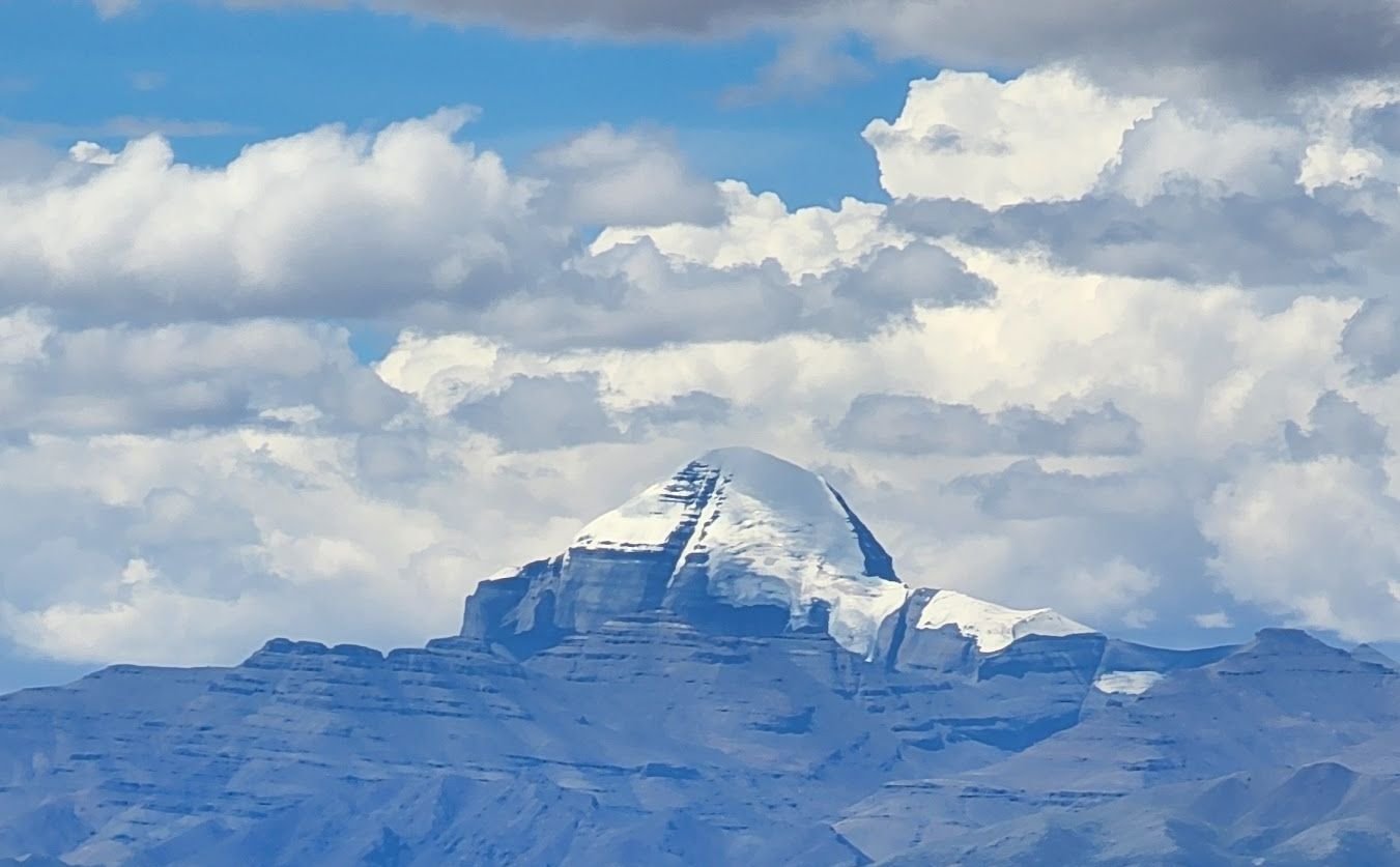 The snow-capped dome of Mount Kailash among clouds
